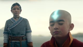Aang (Gordon Cormier) meditating, with Katara ((Kiawentiio) stood to his left in Netflix's Avatar: The Last Airbender episode 2.