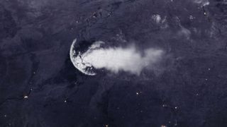A massive jellyfish cloud over a dark land mass