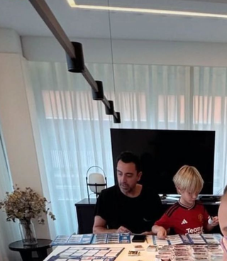 Xavi and his son, who happened to be wearing a Manchester United shirt