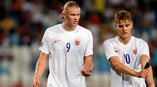 Erling Haaland and Martin Odegaard in conversation during Norway's UEFA Nations League game against Serbia in June 2022.