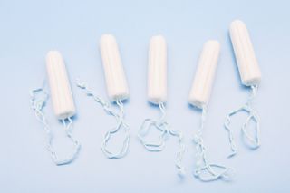 How to look after your vagina: Tampons on blue background