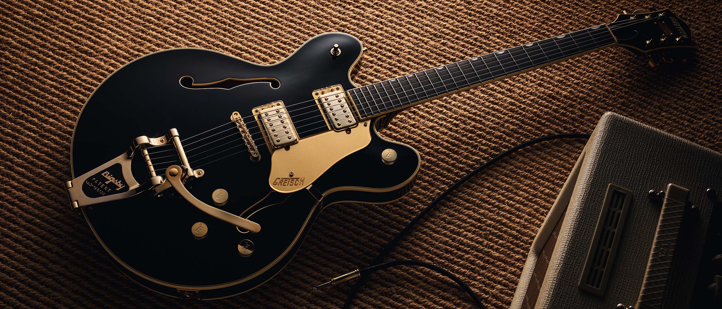 Gretsch Professional Collection Broadkaster LX Center Block: the handsome semi-hollow is finished in black with gold hardware and here is photographed in close-up.