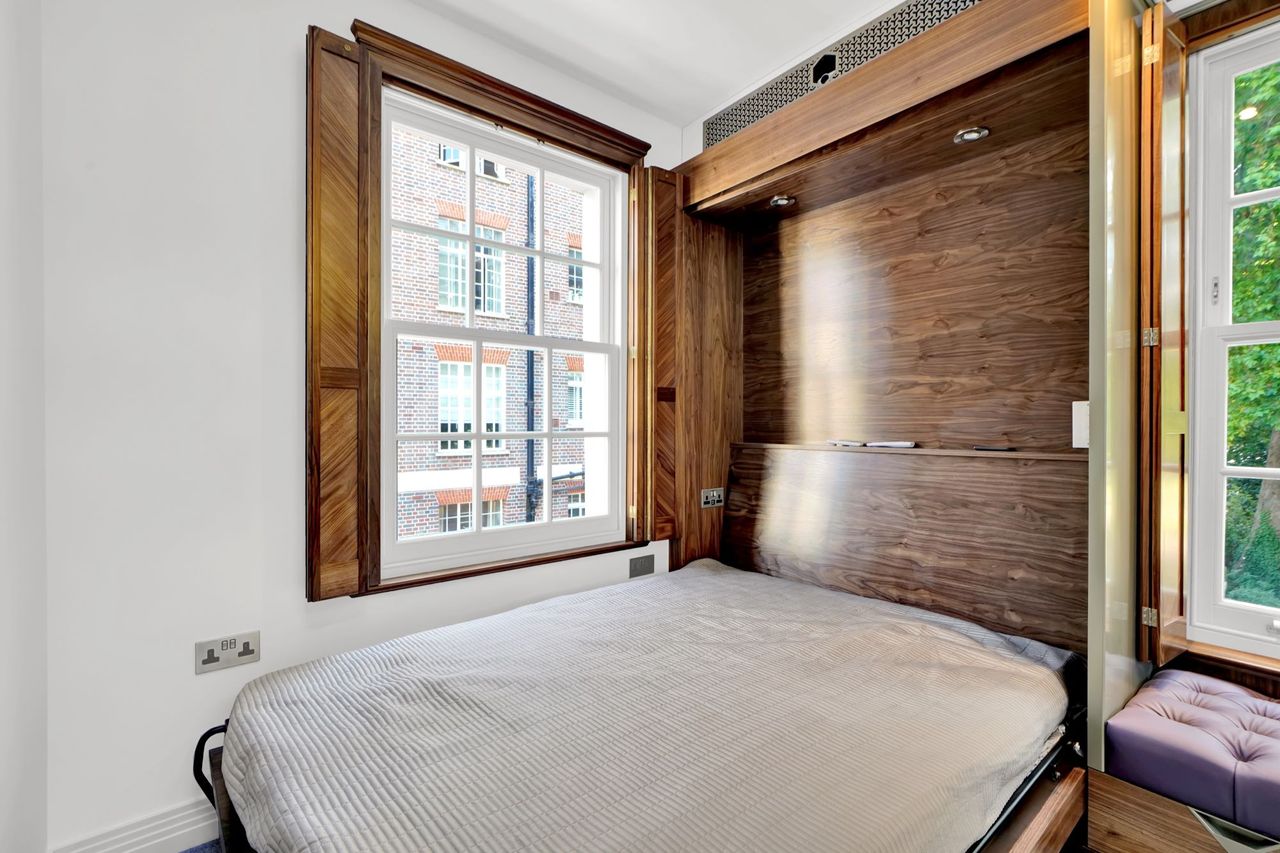 The bed inside the bedroom of the small home