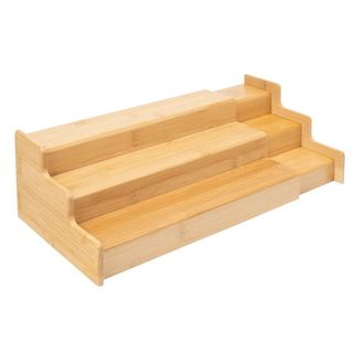 A bamboo extendable three tier shelf riser