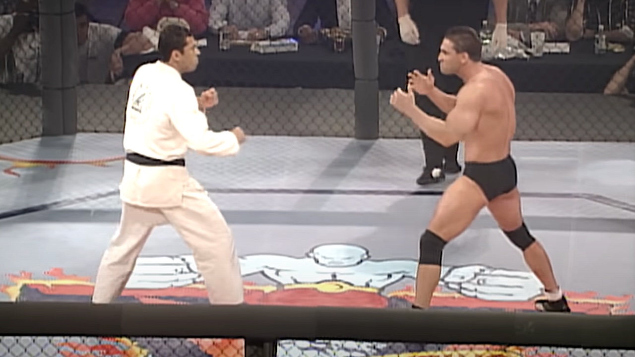 Royce Gracie and Ken Shamrock facing off in the UFC Octagon