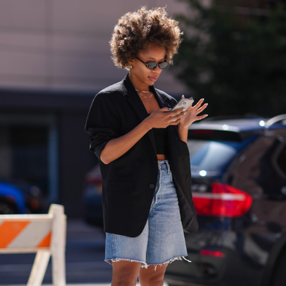 woman wearing a pair of Bermuda shorts and a black blazer