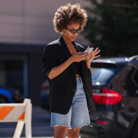woman wearing a pair of Bermuda shorts and a black blazer
