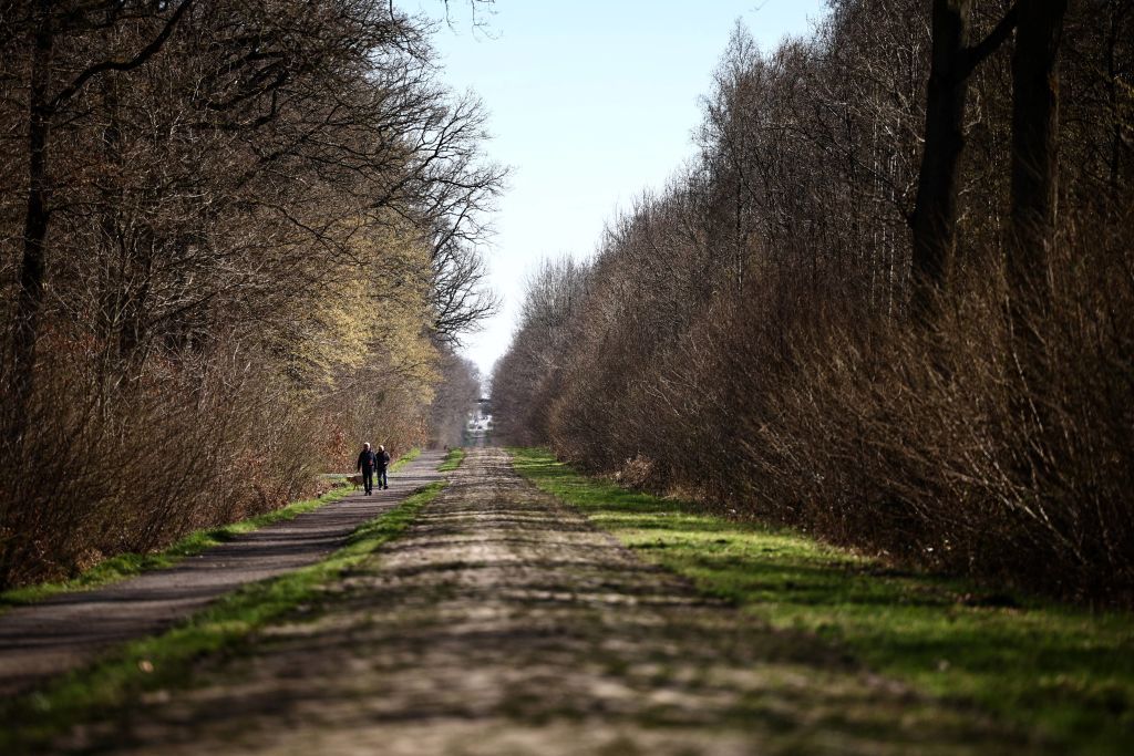 People walk on a section of the Trouee dArenberg classified site strictly protected and forbidden to vehicles and emblematic cobblestone sector of the Paris-Roubaix cycling race on April 4 2023