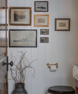 bathroom with vintage art gallery wall
