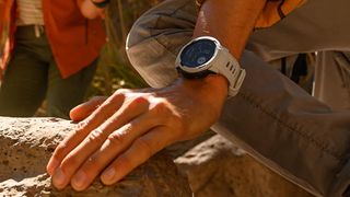 Man hiking wearing Garmin Instinct 2 watch