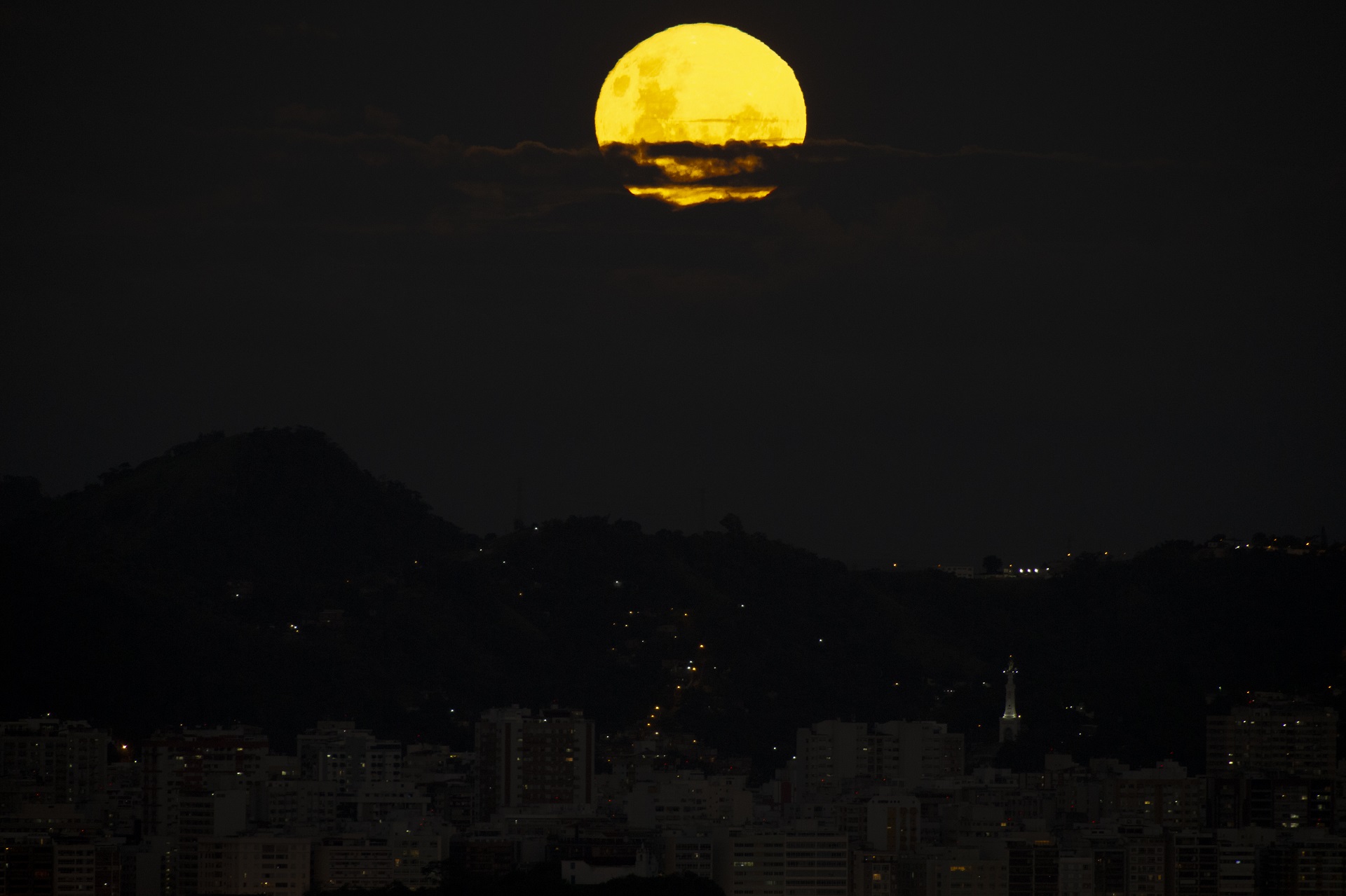 The Blood Moon, a full moon that coincides with a full lunar eclipse and that has a reddish appearance, rises over the city of Rio de Janeiro, Brazil on May 15, 2022.