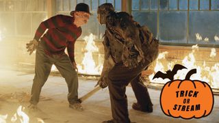 From L to R) Robert Englund as Freddy Krueger and Ken Kirzinger as Jason Voorhees fighting in a burning cabin in Freddy Vs. Jason