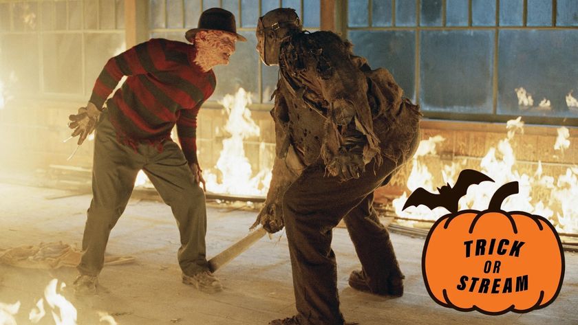 From L to R) Robert Englund as Freddy Krueger and Ken Kirzinger as Jason Voorhees fighting in a burning cabin in Freddy Vs. Jason