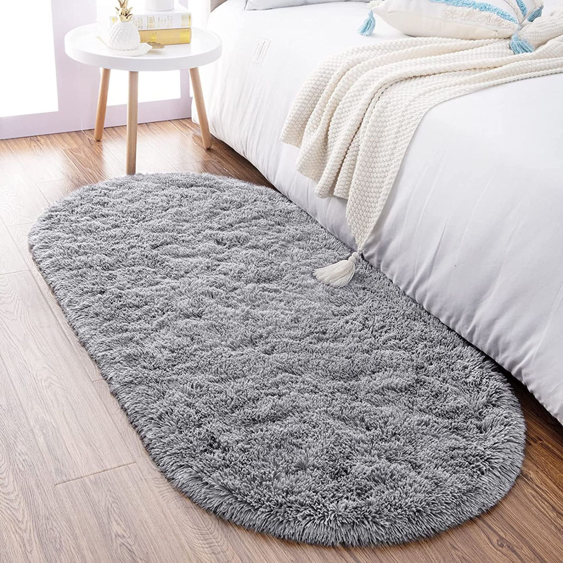 Walmart Ultra Soft Oval Rug on a bedroom floor, beside a bed.