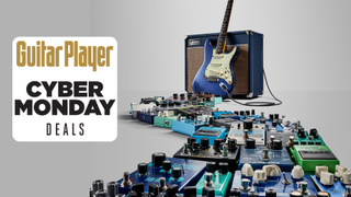 A huge collection of effects pedals snaking their way towards an amp and guitar