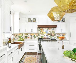 A white kitchen with a colorful botanical mural tile backsplash