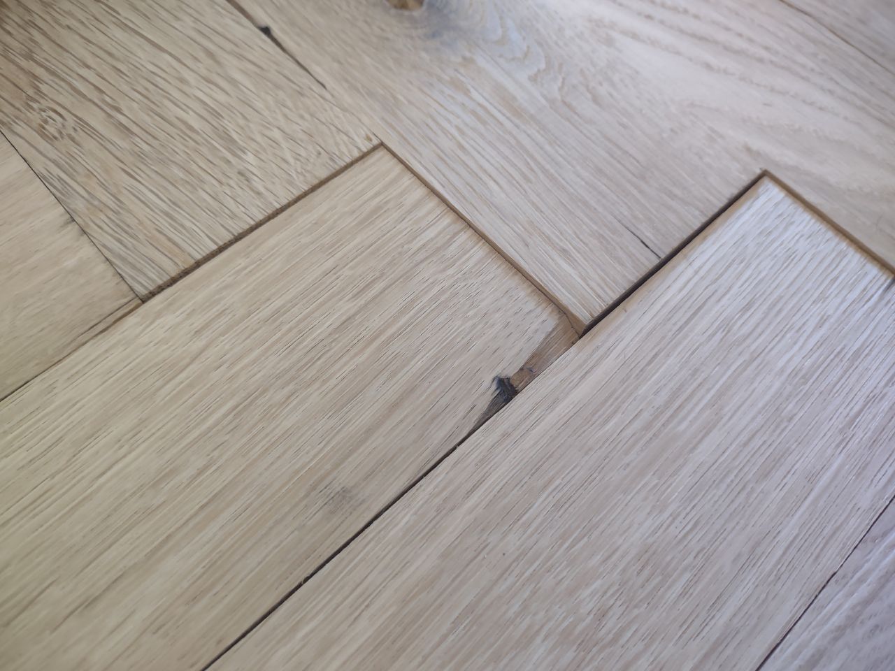 A before shot of a wooden floor before sanding