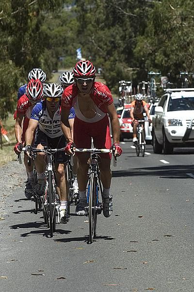Angus Morton of Drapac Porsche steers a group up Mt.Buninyong as they close in on Benjamin King out in front.