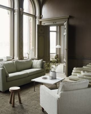 Period living room with Bemz pale green Ikea sofa cover, modern white coffee table and white armchair