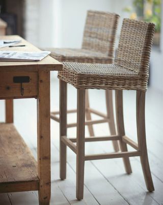 Natural Rattan Bar Stool on a wooden floor at a wooden table