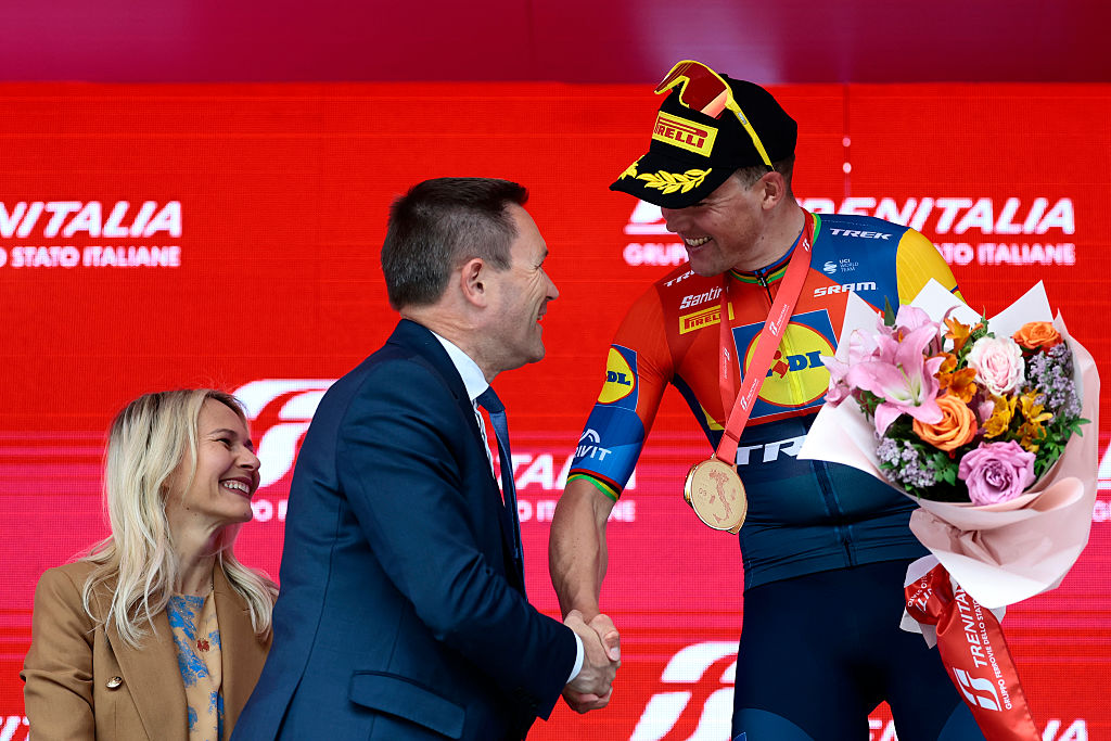 International Cycling Union (UCI) president David Lappartient congratulates Lidl-Trek's Danish rider Mads Pedersen on the podium after he won the first stage of the 108th Giro d'Italia cycling race, 160km from Durres to Tirana in Albania, on May 9, 2025. (Photo by Luca Bettini / AFP)