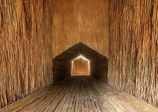 A cocoon-like interior in a residential home lined with local bamboo and straw