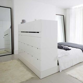 bedroom with headboard and cupboard