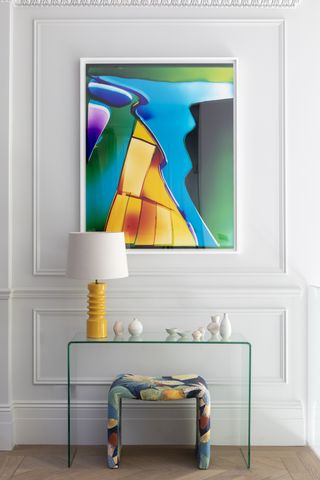 Bright, bold and colorful artwork above console by Kitesgrove