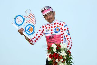 Richard Carapaz of EF Education-EasyPost celebrates on the podium in the polka-dot jersey at the 2024 Tour de France