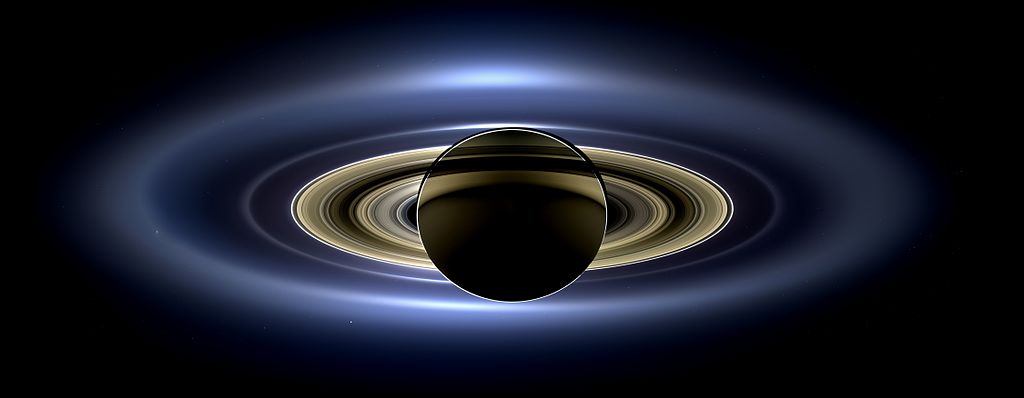 Backlit image of a silhouetted Saturn and it's striking ring structure.