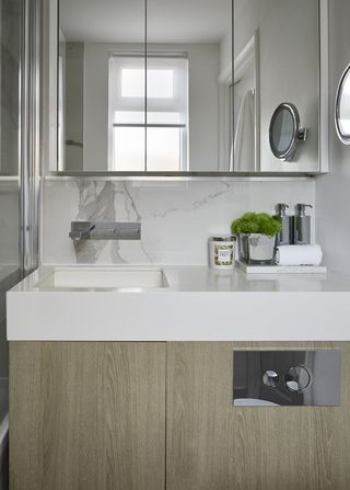 minimalist bathroom with wood cabinets