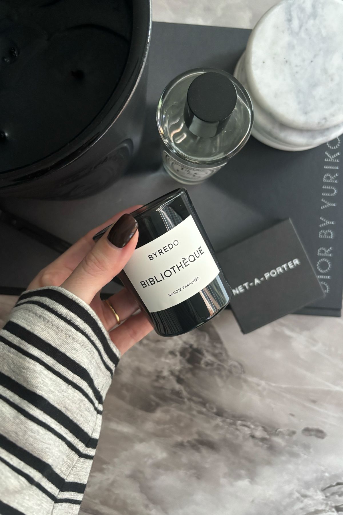 Deputy beauty editor Grace Lindsay holding the Byredo Biblioth&amp;egrave;que candle