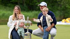Bud Cauley poses with the trophy after his winning putt with his wife Kristi and their two young sons on the 18th hole during the final round of the RBC Canadian Open 