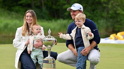 Bud Cauley poses with the trophy after his winning putt with his wife Kristi and their two young sons on the 18th hole during the final round of the RBC Canadian Open 