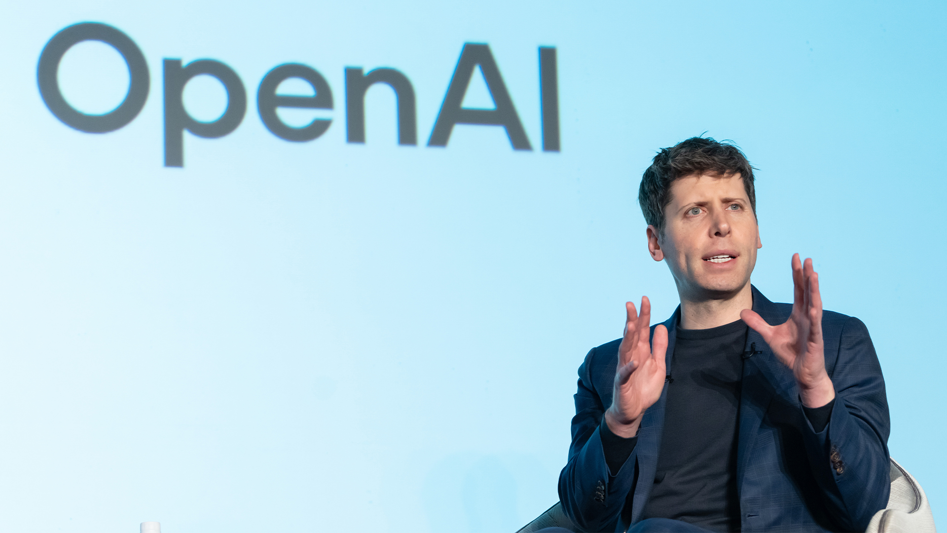 OpenAI CEO Sam Altman pictured speaking with SoftBank Group CEO Masayoshi Son at an event titled "Transforming Business through AI" in Tokyo, Japan.