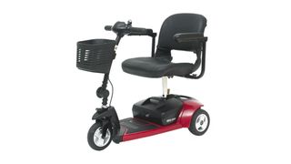 The Pride Travel Pro Premium 3-Wheel Mobility Scooter shown in black with red trim, and with a black plastic storage basket at the front for essentials and groceries
