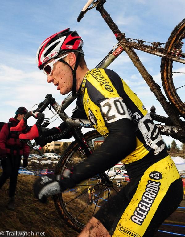 Braden Kappius (University Of Colorado-Boulder) shoulders his bike.