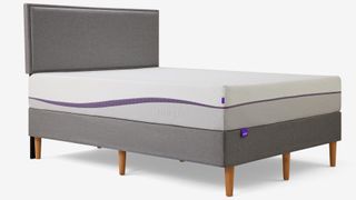 The new Purple Plus Mattress shown on a gray color bed frame with light wood legs
