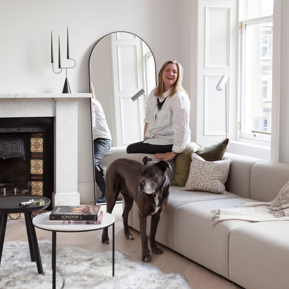 Cathy Dean in a white living room with her dog