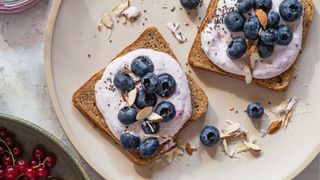 Kefir yogurt with berries topped on wholegrain bread