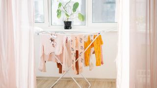 clothes drying on airer next to window