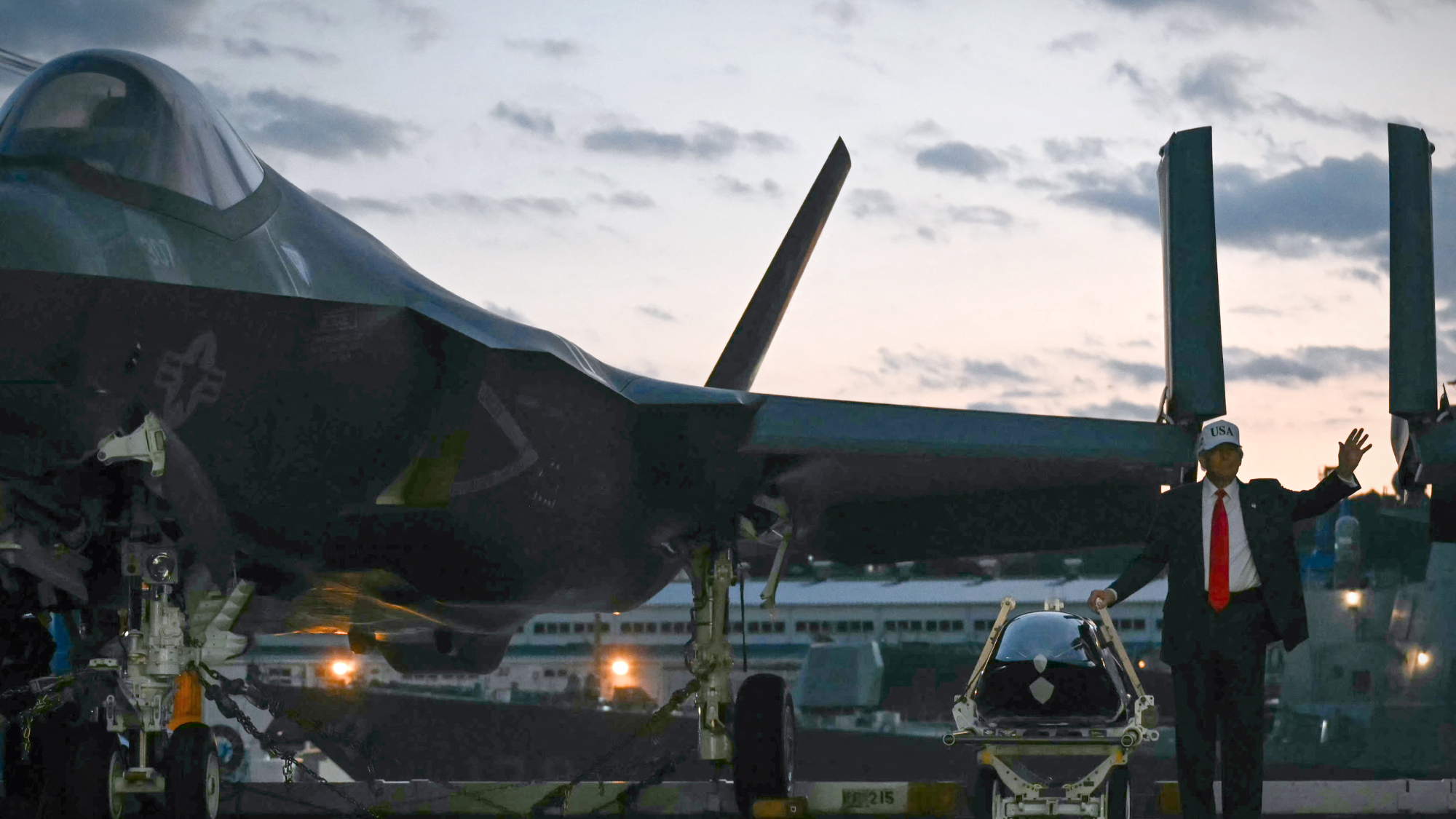 President Donald Trump stands beside an F-35 in Japan