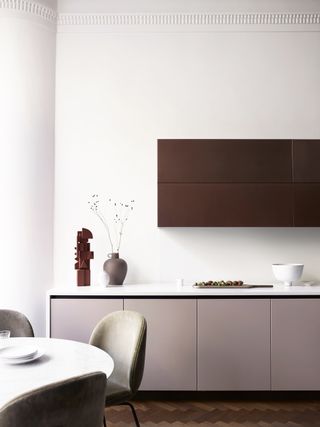 small kitchen with white walls and blush pink cabinets by Roundhouse