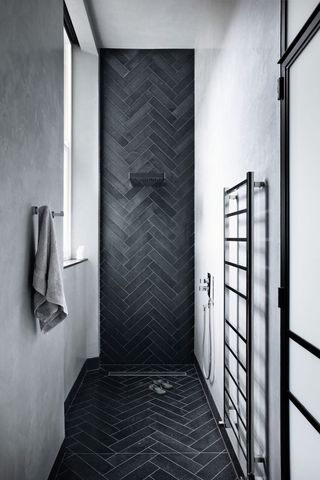 small modern bathroom with black chevron tiles