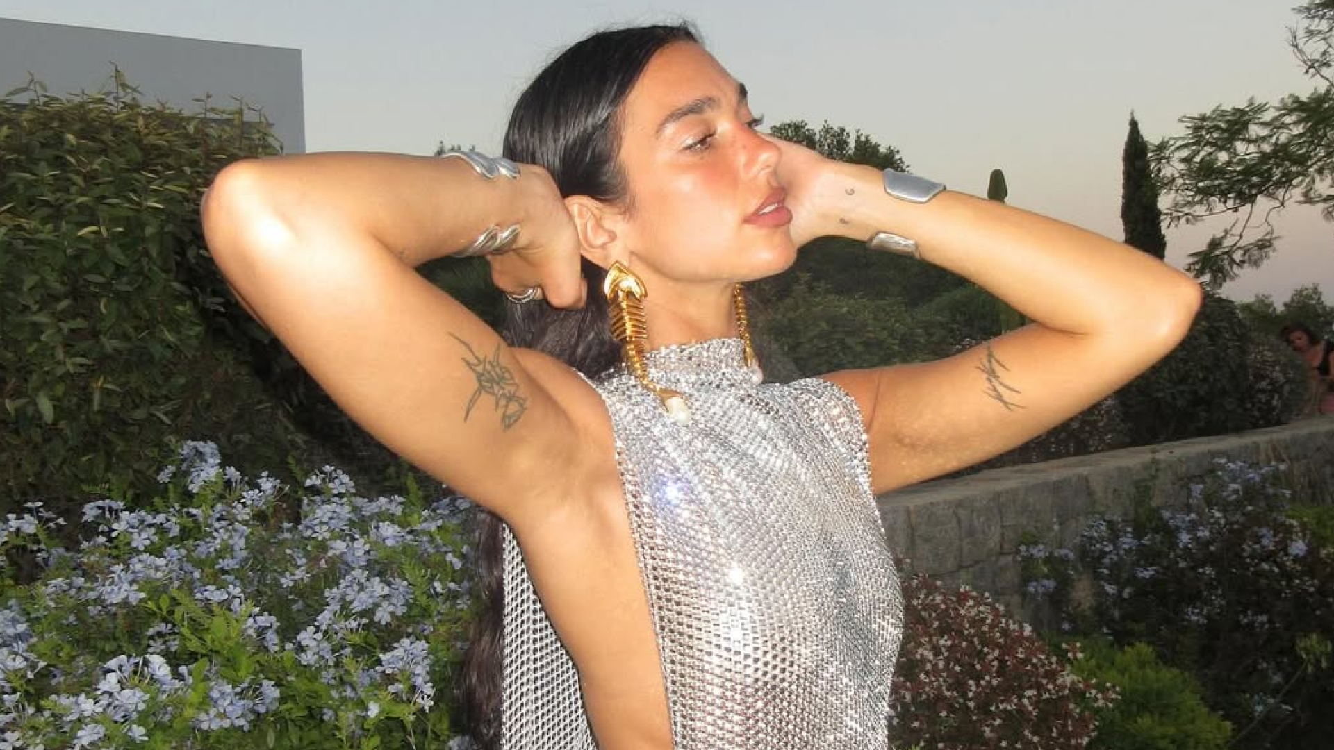 Dua Lipa celebrates her 30th birthday in a custom silver chainmail dress with side splits and open side torso