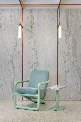 Pastel colour chair, matching stone side table, copper detail and cylinder lights at Infinity Wellbeing, Bangkok