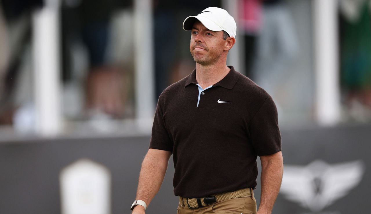 Rory McIlroy smiles as he walks off the green