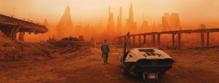 Still image from Blade Runner 2049 - Ryan Gosling walking away from his car in a post-apocalyptic landscape