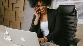 How to clean an office chair: Woman sitting in a clean leather office chair