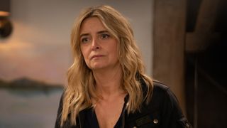 Charity Dingle looks upset at something off camera.